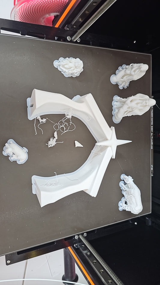 Ana Sousa's 3D printer at the Dr3amToReal studio in Aveiro, with finished printed parts on the bed