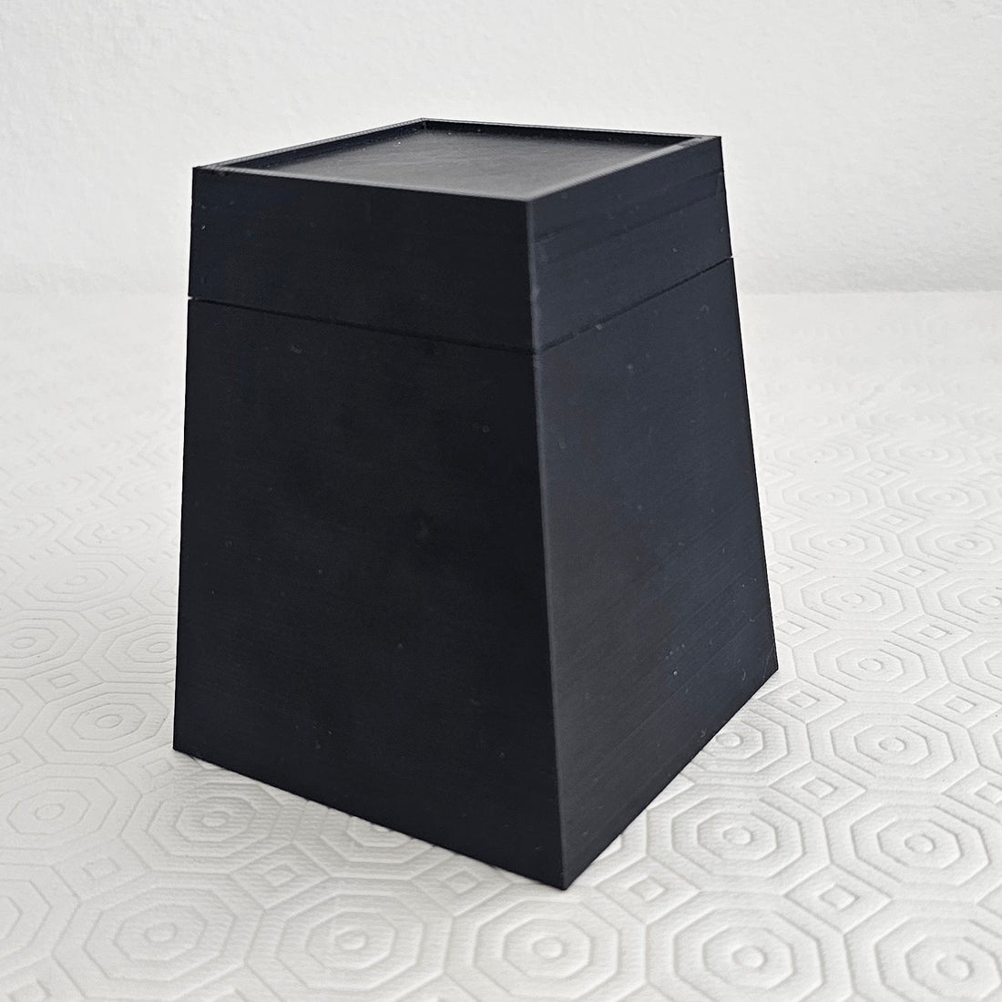 The finished dog-grooming block, assembled: a black 3D-printed square taper with the cap seated