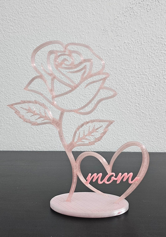 Decorative wall art with a rose design and 'mom' on a gray background